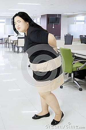 Obese businesswoman suffering backache Stock Photo