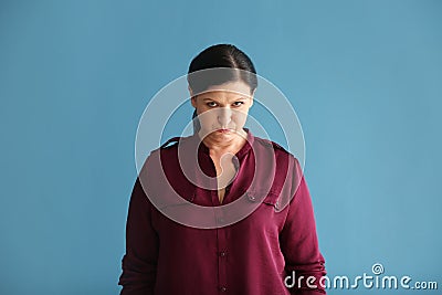 Portrait of offended mature woman on color background Stock Photo