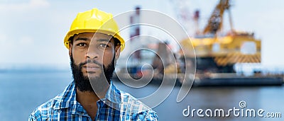 Portrait of offshore worker with digger and ocean Stock Photo
