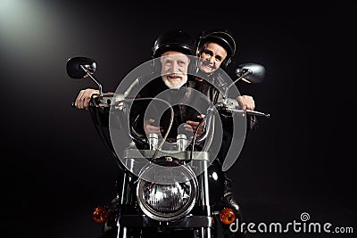 Portrait of old cool man drive chopper motor bike ride his wife enjoy free dome extreme lifestyle adventure wear vintage Stock Photo