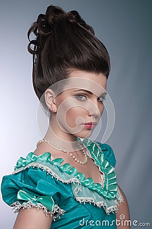 Portrait of old fashioned girl in cyan dress Stock Photo