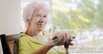 Portrait Old Lady Sitting On Rocking Chair Holding Stick Stock Photo