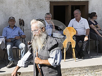 Portrait of Old Man and tourists Editorial Stock Photo