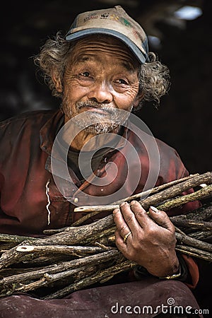 Portrait of a old nepalese man in cap in his house Editorial Stock Photo