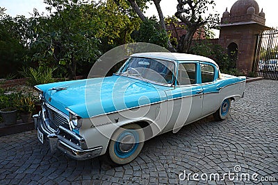 Old retro blue commander vintage car parked at driveway of a house, outdoor natural background, vintage car Editorial Stock Photo