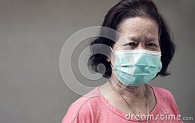 Portrait of old woman wearing mask to protect virus Stock Photo