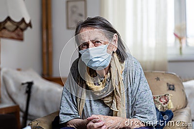 Portrait of old woman wearing surgical mask Stock Photo