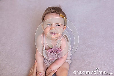 Portrait of a one year old girl, purple background. Stock Photo