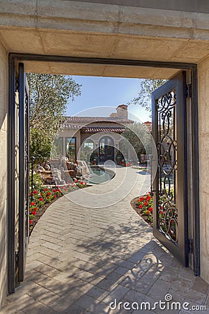 Open gate with path leading to front door Stock Photo