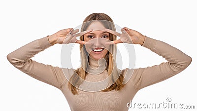 Portrait of optimistic blond girl showing peace sign over eye and smiling, white background. Just be cool about it Stock Photo