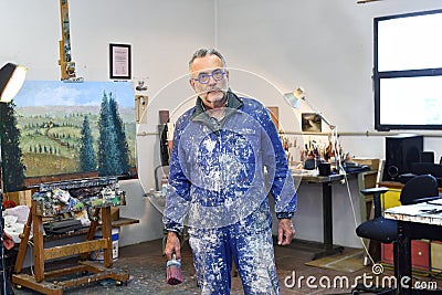 Portrait of a painter artist who works in his studio Stock Photo