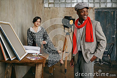 Portrait painter and female model in art studio Stock Photo