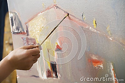 Portrait of painter using brush to paint Stock Photo