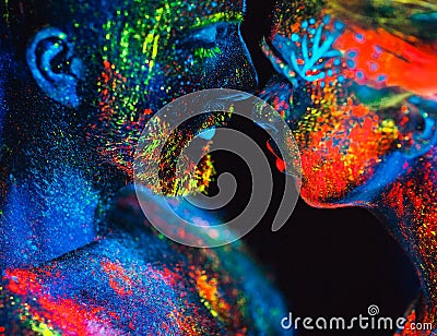 Portrait of a pair of lovers painted in fluorescent powder. Stock Photo