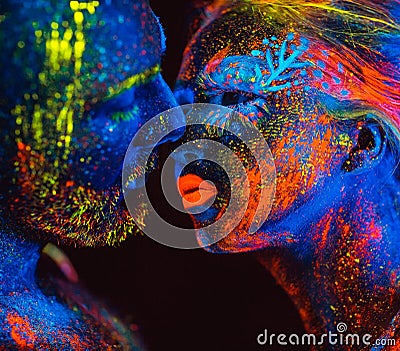 Portrait of a pair of lovers painted in fluorescent powder. Stock Photo