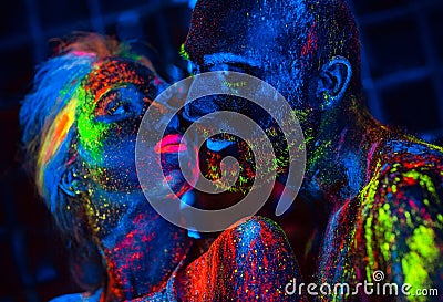 Portrait of a pair of lovers painted in fluorescent powder. Stock Photo