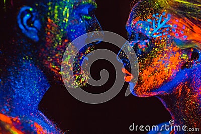 Portrait of a pair of lovers painted in fluorescent powder Stock Photo