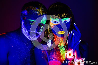 Portrait of a pair of lovers painted in fluorescent powder Stock Photo