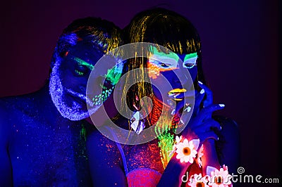 Portrait of a pair of lovers painted in fluorescent powder Stock Photo