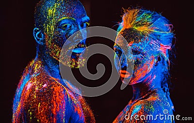 Portrait of a pair of lovers painted in fluorescent powder. Stock Photo