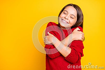Portrait of peaceful calm kid hug embrace herself enjoy warm soft comfy sweater pullover wear red stylish lifestyle Stock Photo