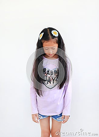 Portrait of peaceful little asian girl looking down isolated on white background Stock Photo