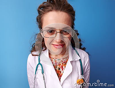 Portrait of pediatrist doctor in white medical robe on blue Stock Photo