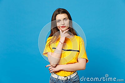 Portrait of pensive boring young woman in vivid casual clothes looking camera, put hand prop up on chin isolated on Stock Photo