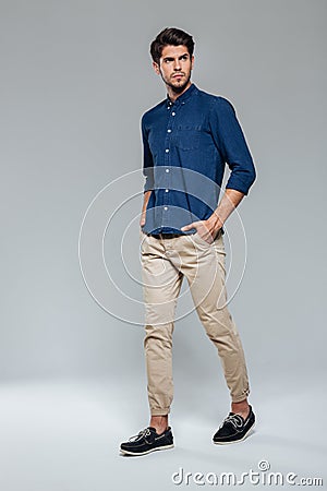 Portrait of pensive handsome man posing with hands in pockets Stock Photo