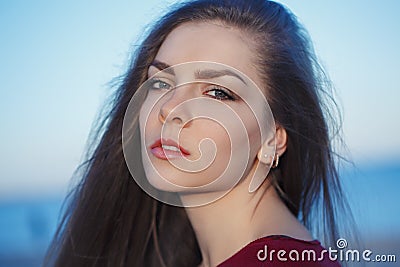 Portrait of pensive sad lonely Caucasian young beautiful woman with messy long hair Stock Photo