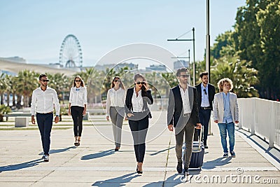 People in official clothes walking together on business trip Stock Photo