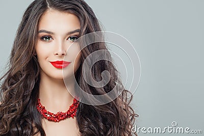 Portrait of perfect brunette woman with red lips makeup and long curly hair Stock Photo