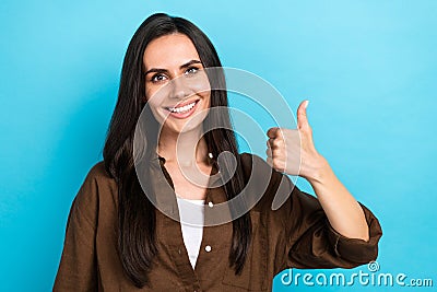 Portrait photo of cheerful cute girl appoint good quality product raise thumb finger up alright yes ok isolated blue Stock Photo