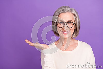 Portrait photo of cheerful pensioner woman advertiser hold hand new product medicine help with migraine on Stock Photo