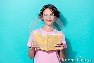 Portrait photo of young cute pretty woman wear pink t-shirt hold yellow book diary nerd isolated on cyan color Stock Photo