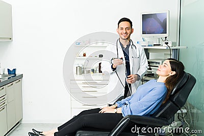 Portrait of a physician with a patient at his office Stock Photo