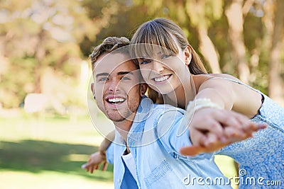 Portrait, piggy back and couple in a park, love and happiness with marriage and romance. Face, man carrying woman or Stock Photo