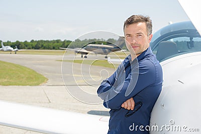 Portrait pilot stood next to aircraft Stock Photo
