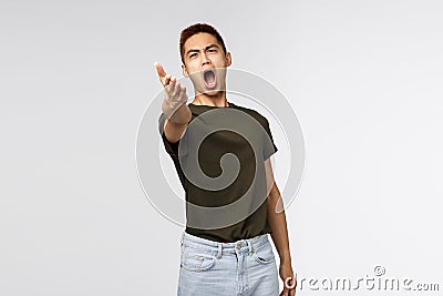 Portrait of pissed-off complaining, bothered asian man pointing with dismay at camera and accuse someone, look angry and Stock Photo