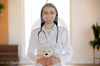 Portrait of pleasant smiling nurse holding toy. Stock Photo