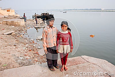 Portrait of poor children having fun near river Ganga, in ancient indian city Editorial Stock Photo