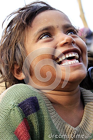 Portrait of a poor little smiling girl. Wow moment. Editorial Stock Photo