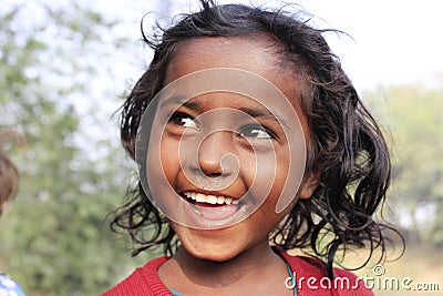 Portrait of a poor little smiling girl. Wow moment. Editorial Stock Photo