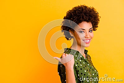 Portrait of positive afro american girl point forefinger copy space present tips pick ads feedback demonstrate choice Stock Photo