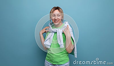 portrait of a positive bright young woman in a casual outfit on a blue background with copy space Stock Photo