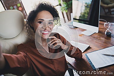 Portrait of positive pretty lady recruiter sitting chair take selfie toothy smile workplace desk business center inside Stock Photo