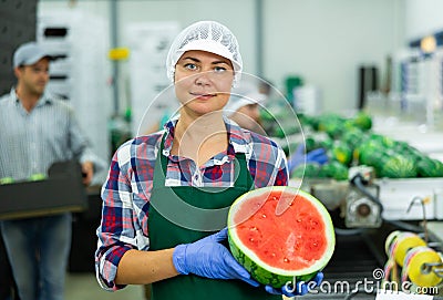 Portrait of positive woman fruit factory worker with watermelon Stock Photo