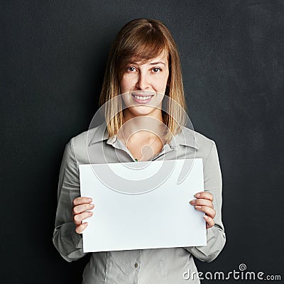 Portrait, poster and mock up with a woman in studio on a dark background holding a blank sign. Announcement, information Stock Photo
