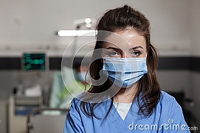 Portrait of practitioner nurse wearing protective face mask to prevent infection with coronavirus Stock Photo