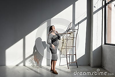 Portrait of a pregnant girl with closed eyes. Stock Photo